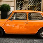 Retro car orange color purity in the street