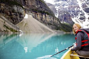 A woman canoeing on Moraine Lake, a tight crop with copy space