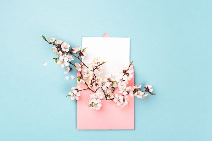 Pink envelope with spring flower.