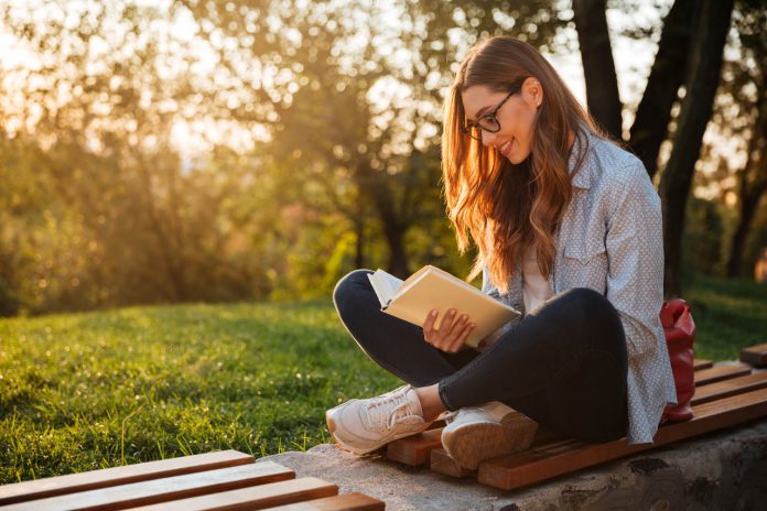 Side,View,Of,Pleased,Brunette,Woman,In,Eyeglasses,Sitting,On