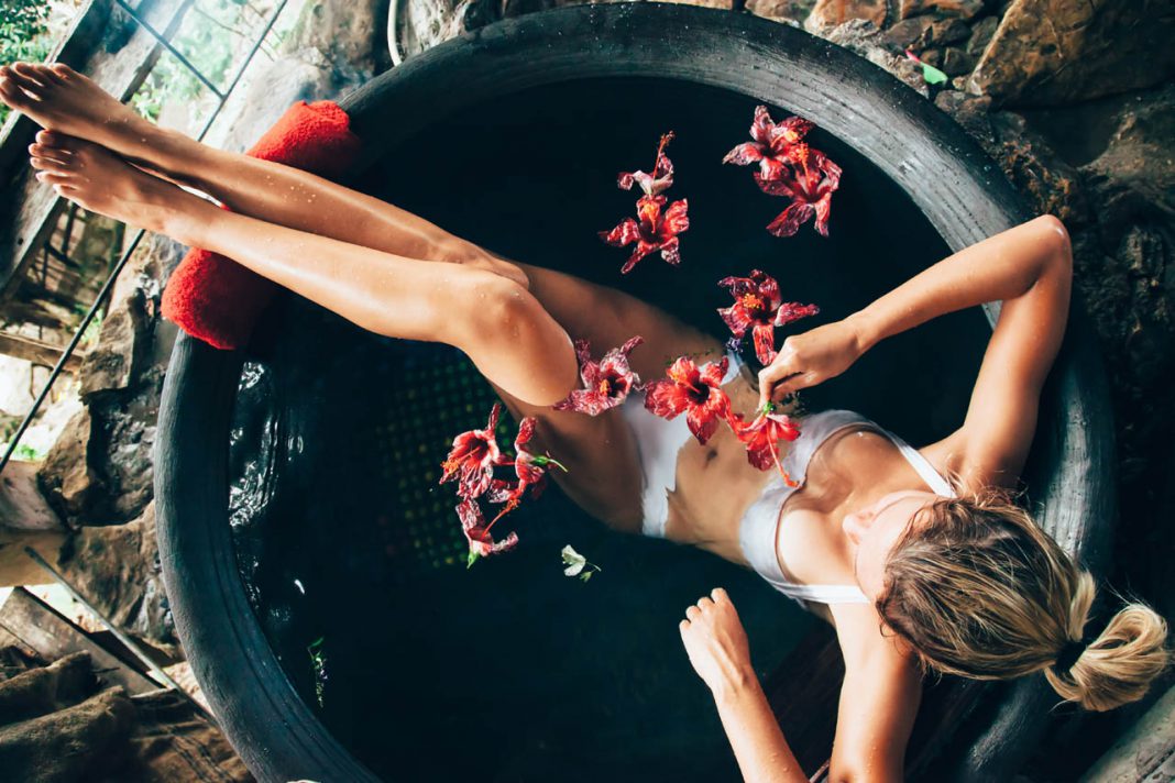 Woman,Relaxing,In,Round,Outdoor,Bath,With,Tropical,Flowers.,Organic