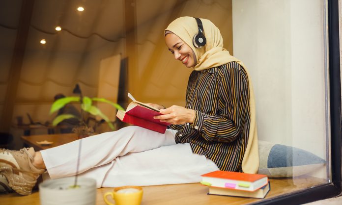 Beautiful arab girl in hijab and headphones