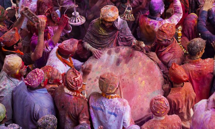Festival of Colours,India,High angle view of crowds of people covered in colour at Holi, a Hindu spring festival.