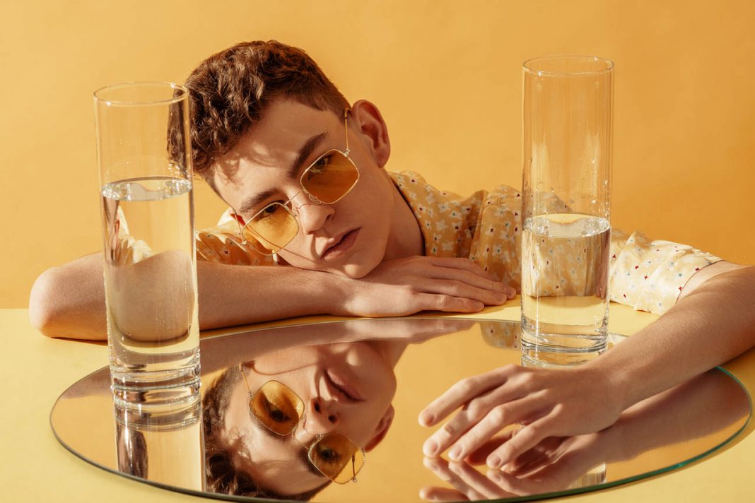 Young,Fashionable,Man,Wearing,Trendy,Sunglasses,,Posing,On,Yellow,Background.